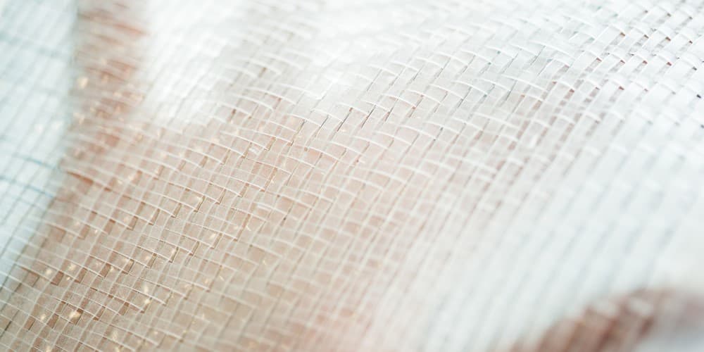 close-up of woven textile with grid pattern Close-up of woven textile with a subtle grid pattern and soft beige tones