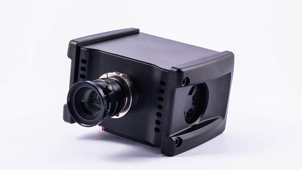 Compact hyperspectral camera with large lens Compact black hyperspectral camera with a large lens on a white background