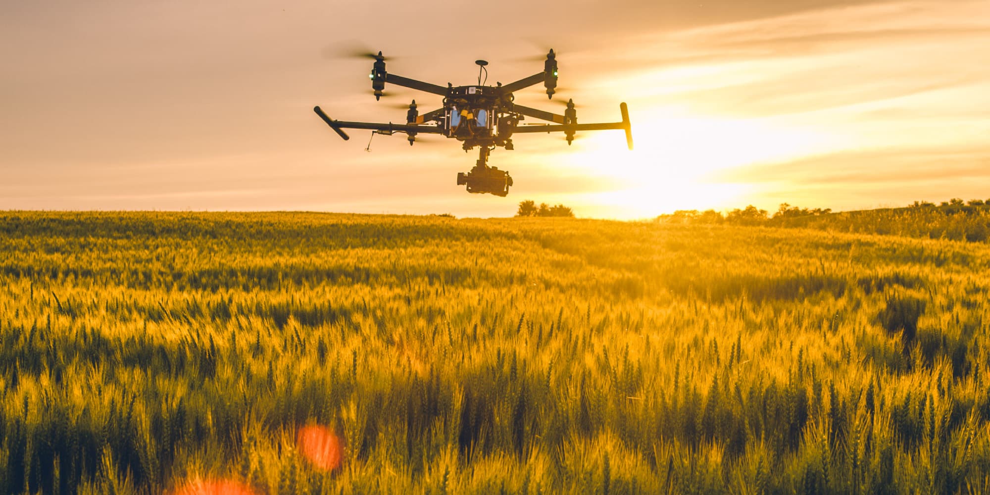 Agriculture Drone flying over a crop field at sunset for agricultural hyperspectral imaging