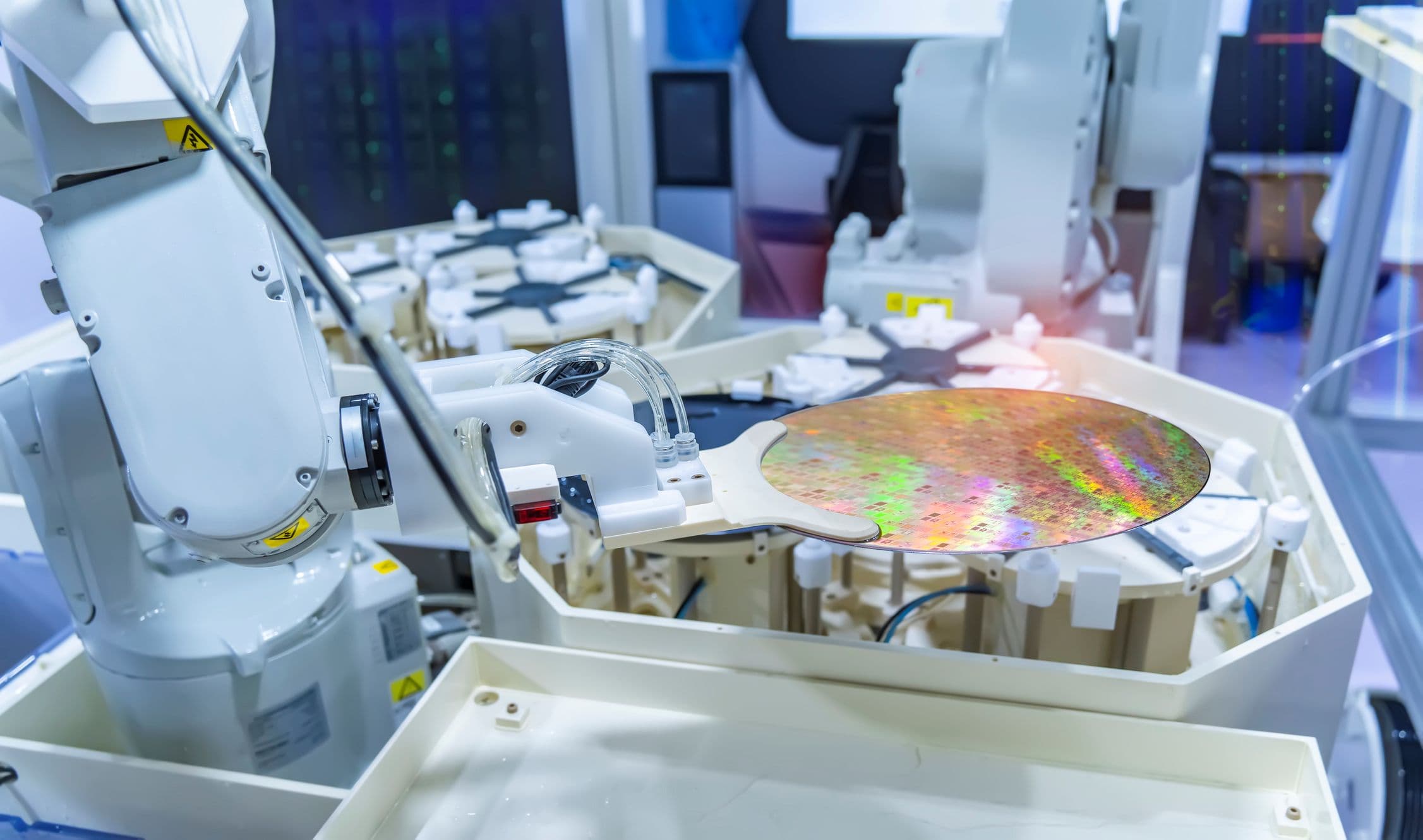 ASIC%20manufacturing Semiconductor wafer handled by robotic equipment in a cleanroom manufacturing line