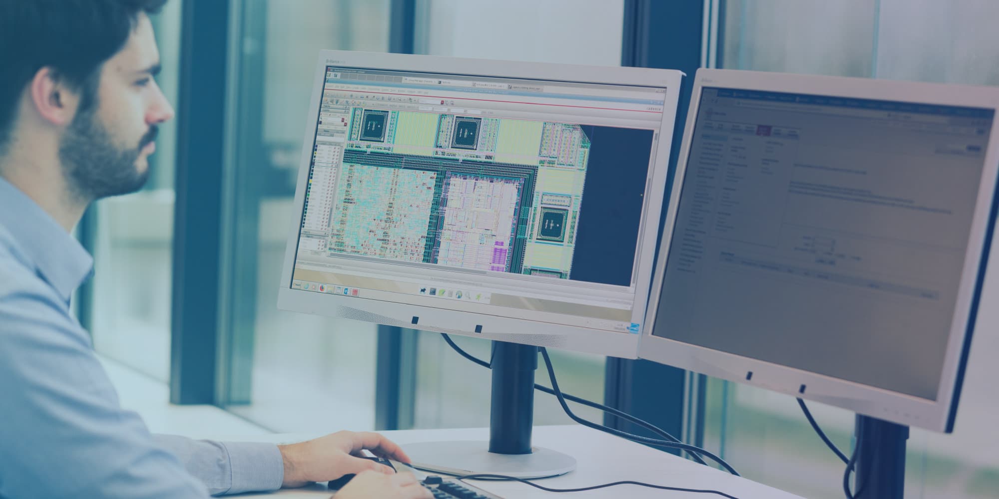 ASIC-services_0 Engineer reviewing chip layout on dual monitors