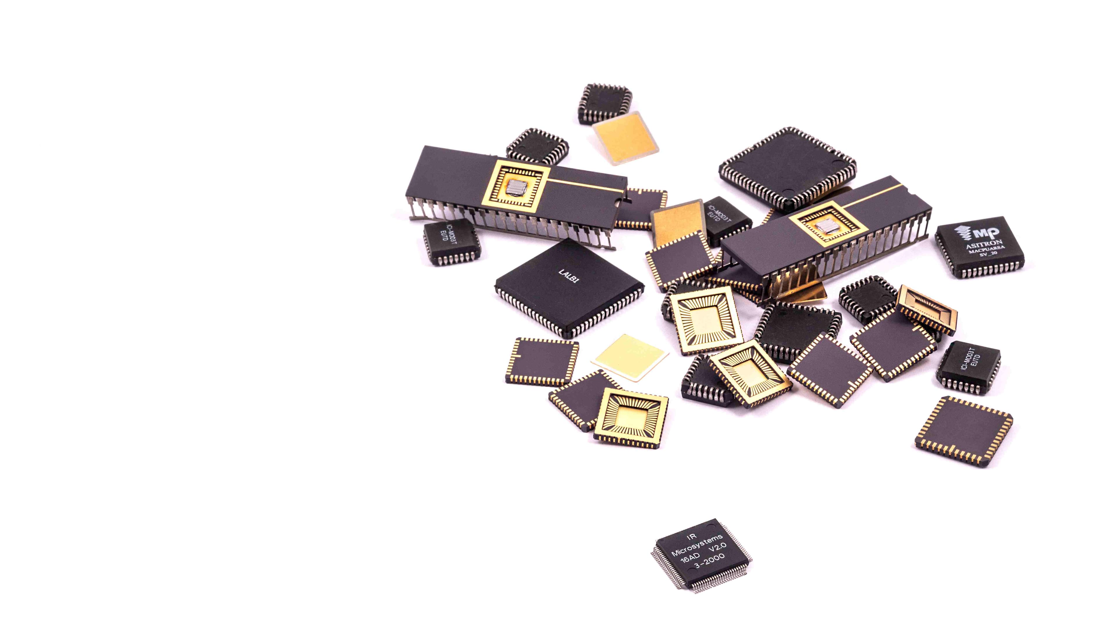Manufacturing%20ASIC Assorted packaged microchips arranged on a white background
