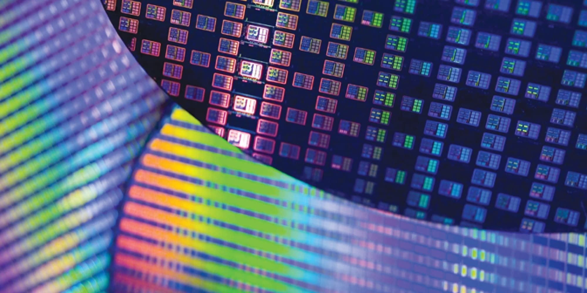 TSMC-University-FinFET-Program Colorful close-up of a semiconductor wafer with patterned chip dies