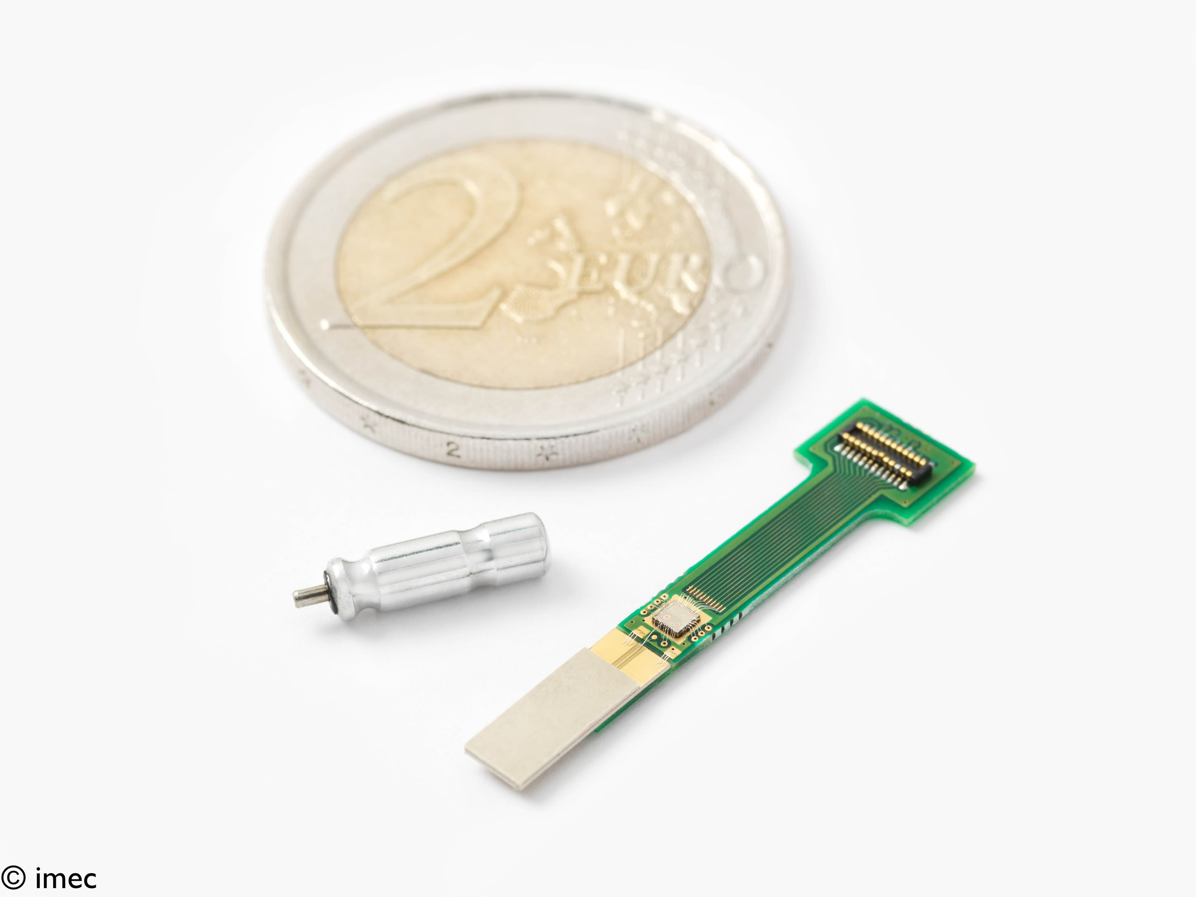 Ingestible pill mock-up with prototype transceiver and coin Mock-up of an ingestible pill with a prototype transceiver beside a coin for scale