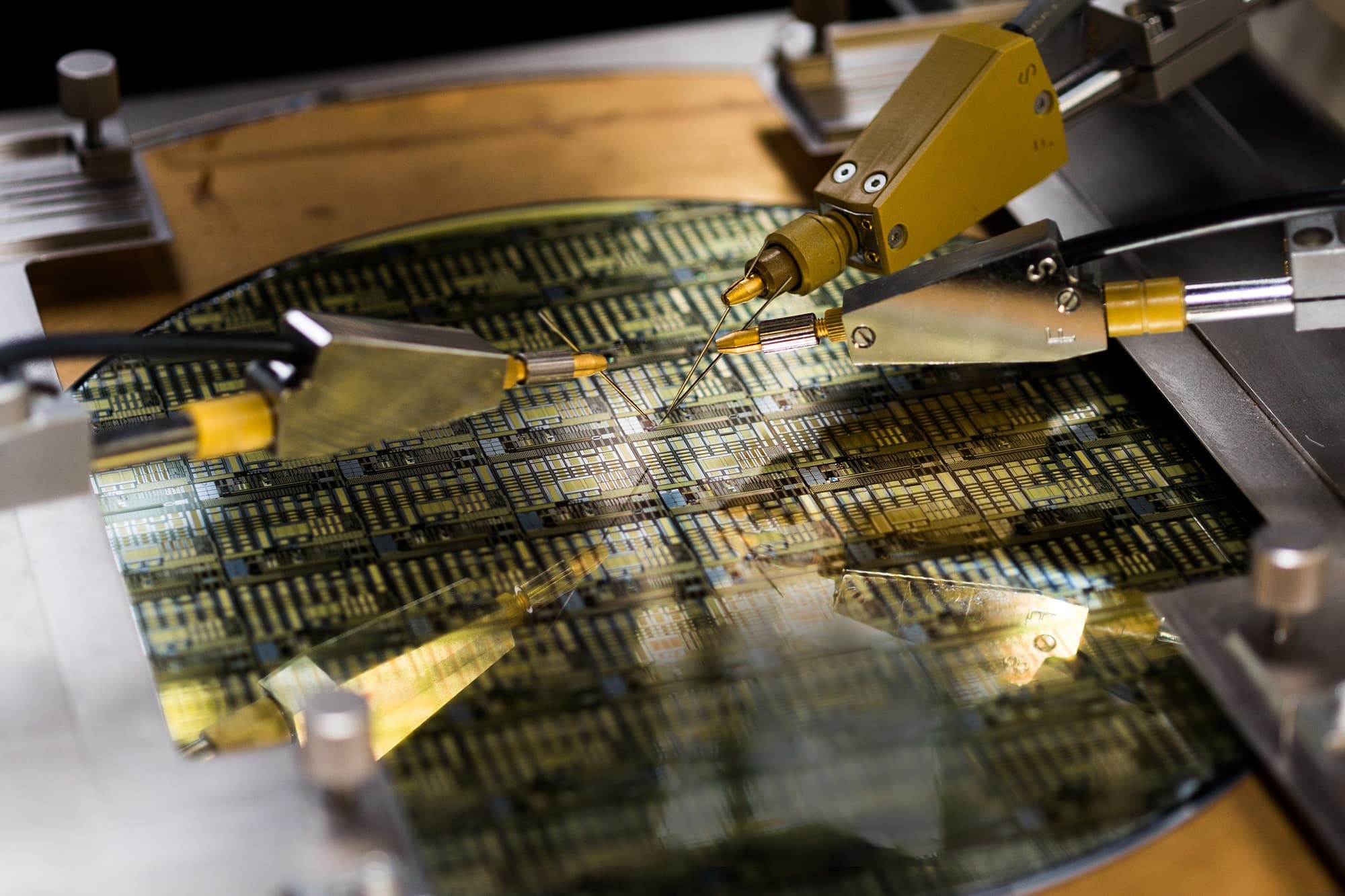 200mm-GaN--high-power-probe003_low_1 Probe needles testing a patterned semiconductor wafer on a wafer probe station