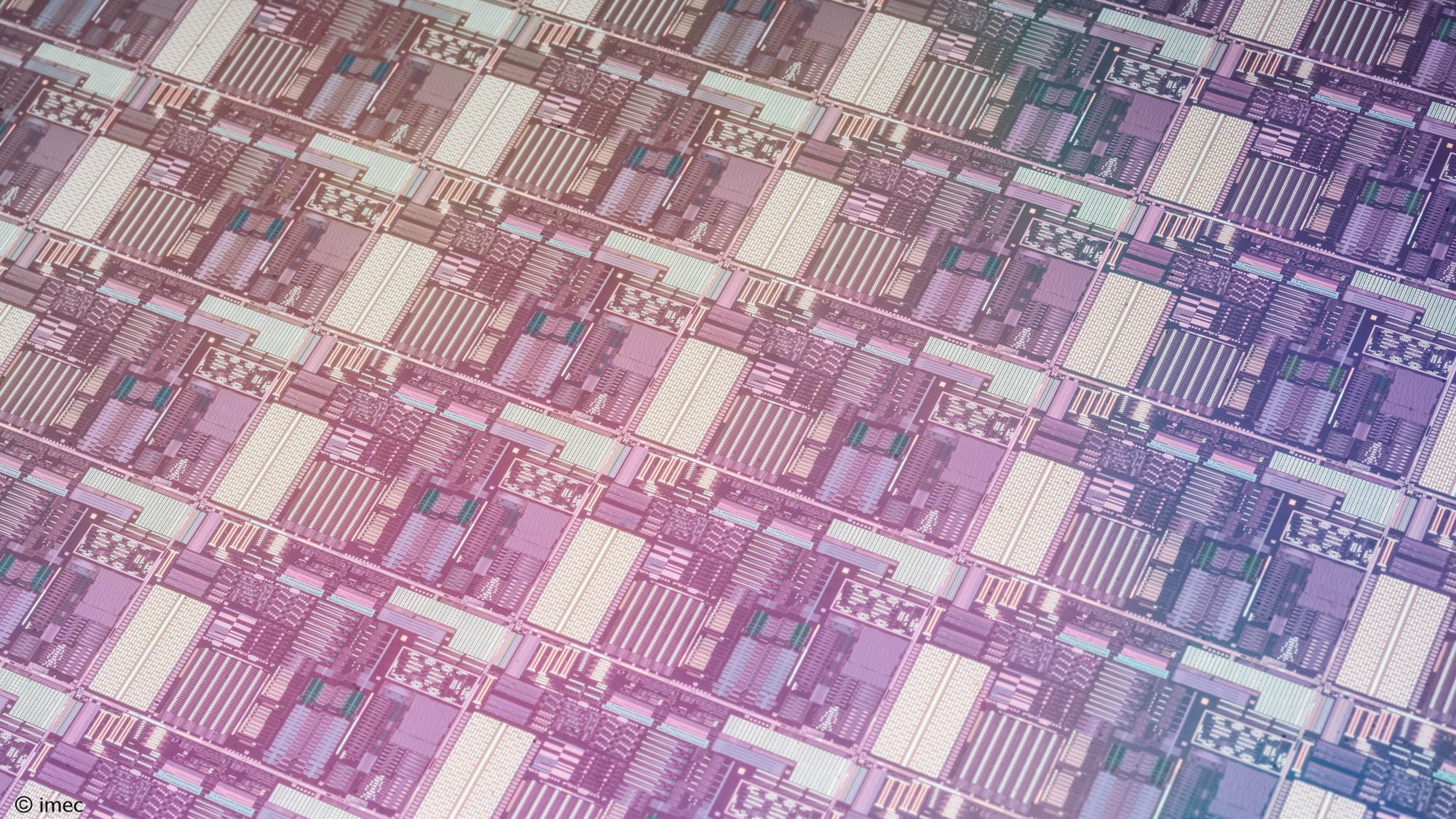 206-Wafer-processed-on-SiPho-platform002 Colorful close-up of a semiconductor wafer with repeating chip patterns