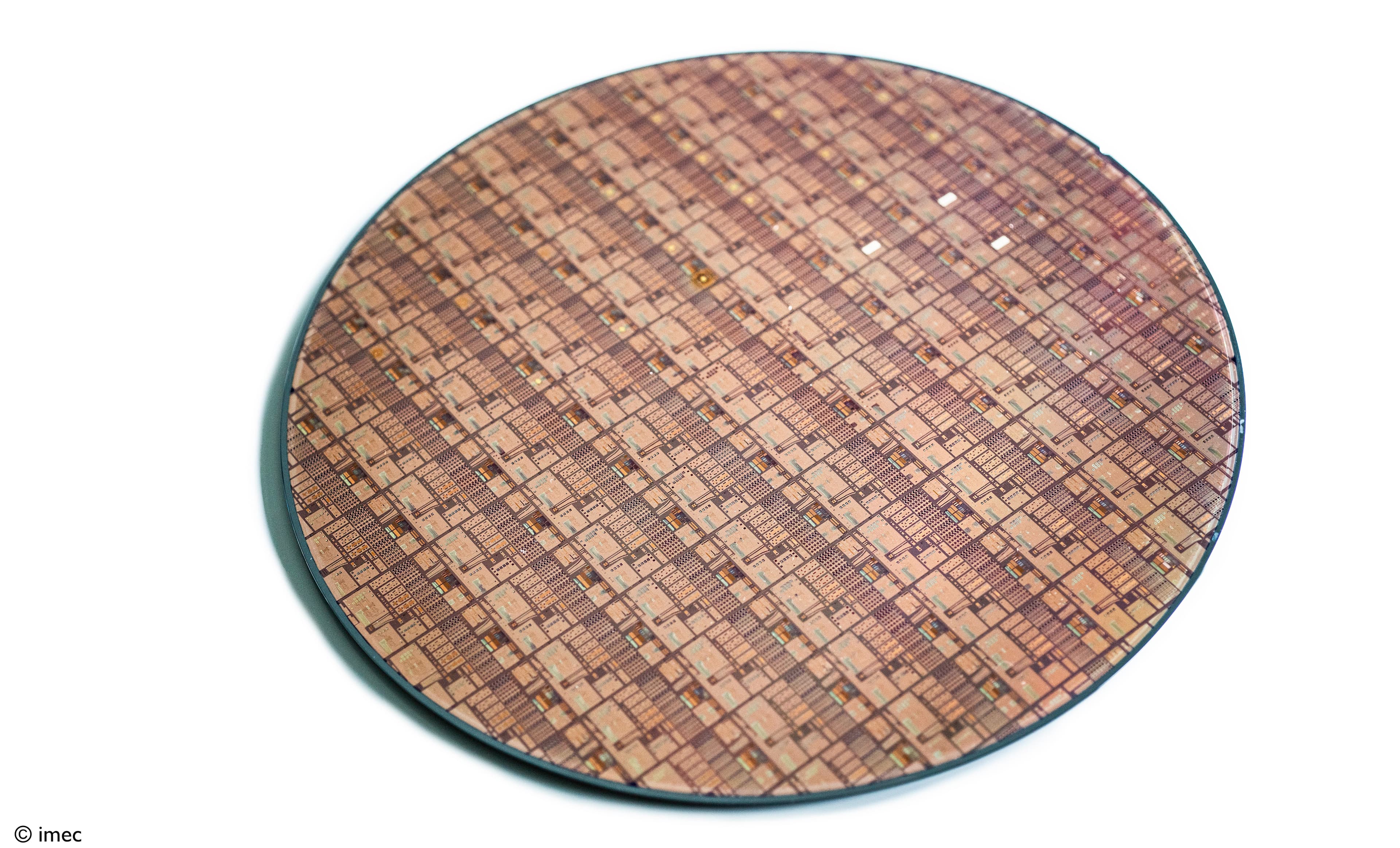 2164_PR_325GHz-RF-Si-Interposer-Platform-for-Advanced-Chiplet-Based-Heterogeneous-Systems Silicon wafer covered with a dense chip pattern, shown on a white background