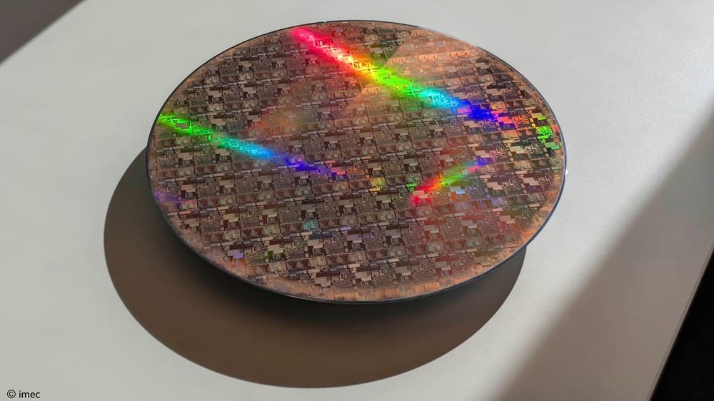 300mm_wafer Silicon wafer with rainbow reflections and a detailed chip pattern on a display stand