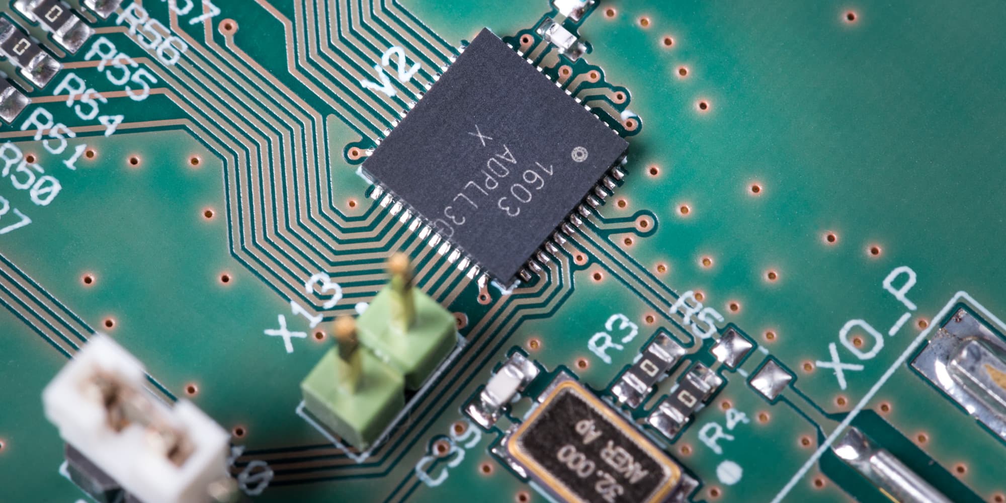 Close-up of circuit board with integrated circuit Close-up of a circuit board with a central integrated circuit and fine copper traces