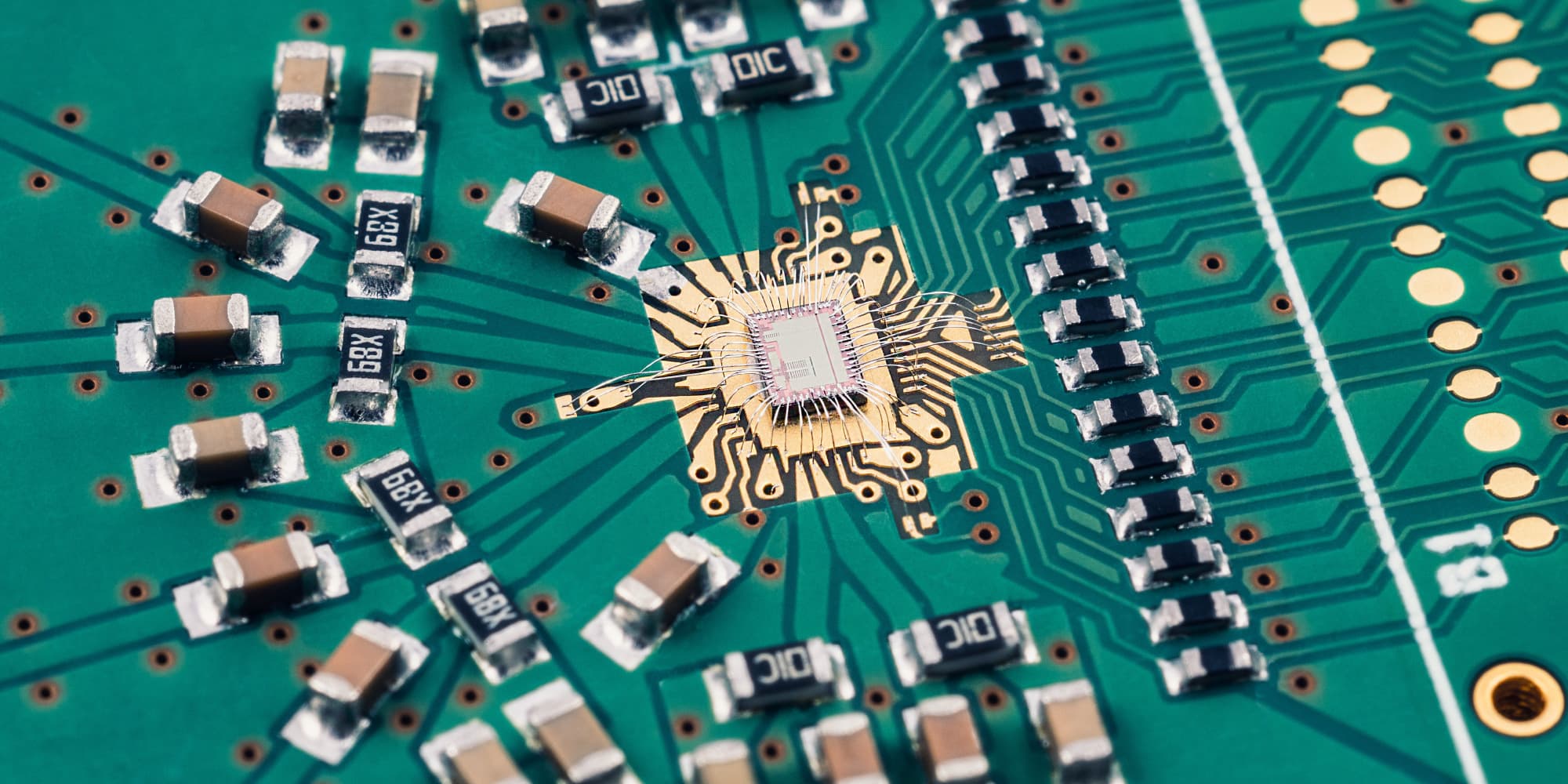 close-up of circuit board with microchip Close-up of a circuit board with a central microchip and surrounding components