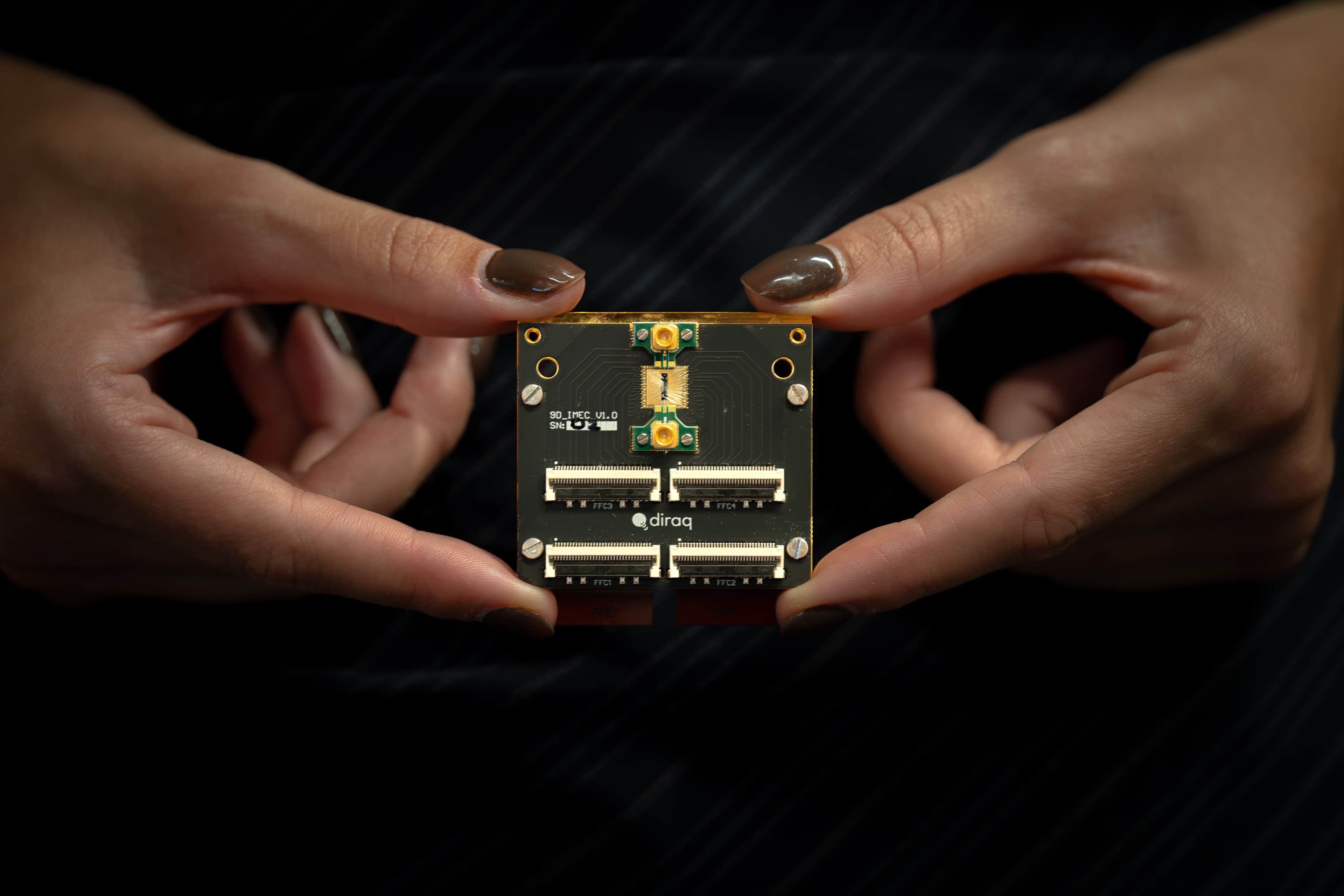 8%20qubit%20chip%20photo%20for%20Andi%27s%20paper Hands holding a silicon quantum chip with the Diraq logo