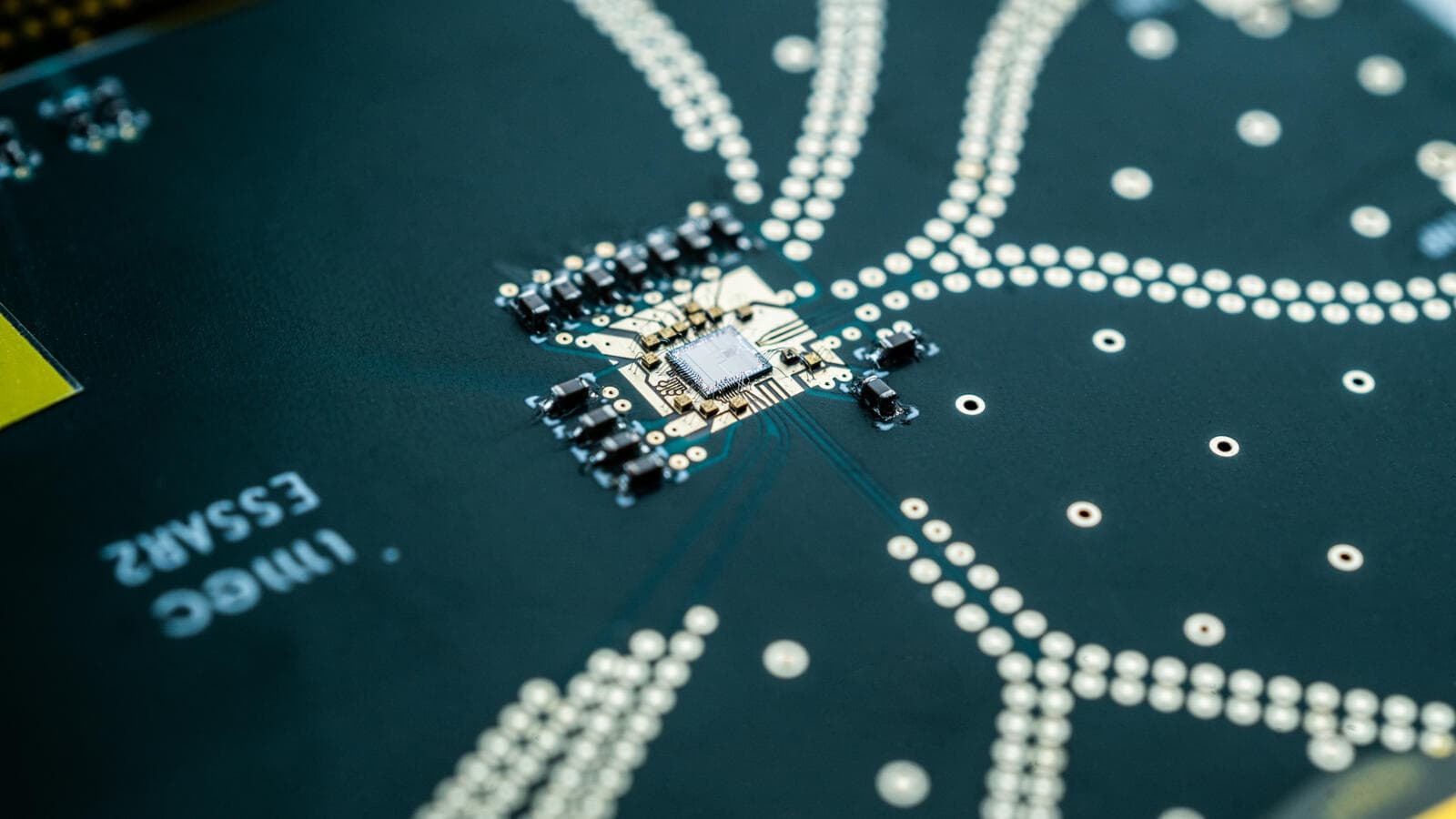 ADC Close-up of an ADC circuit board with a central chip and dotted signal traces
