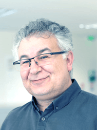 Alaa%20Makdissi Alaa Makdissi smiling in a dark button-up shirt