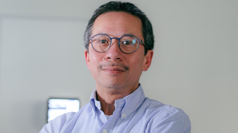 An-Nguyen-Dinh An Nguyen-Dinh portrait wearing glasses and a blue shirt