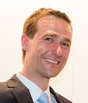 bas_van_de_kreeke_1 Portrait of Bas van de Kreeke smiling in a suit and tie