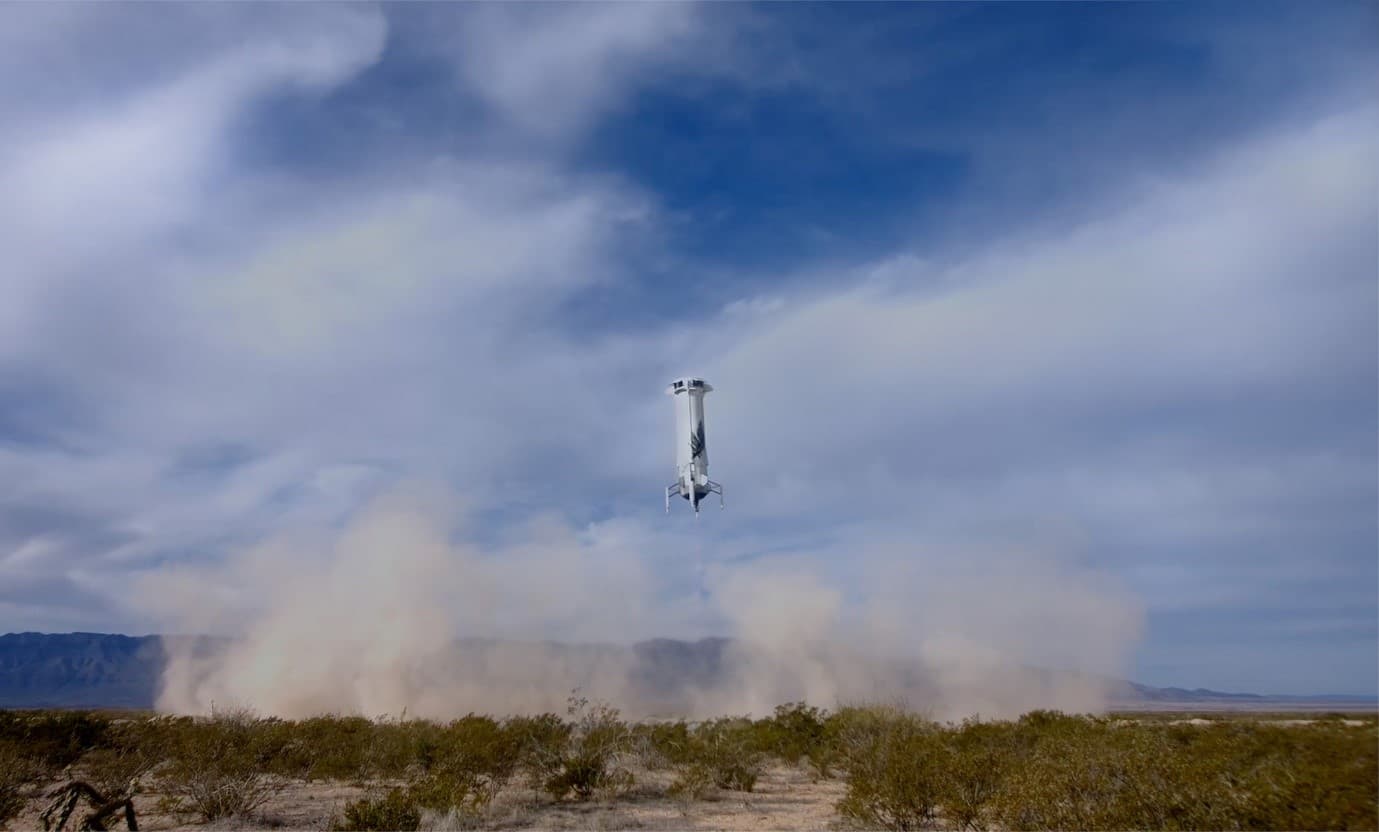 BlueOrigin_NS-24_RocketLanding Blue Origin’s New Shepard booster descending toward the desert landing pad amid dust and smoke