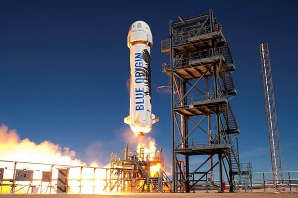 BlueOrigin_NS_Rocket Blue Origin New Shepard rocket launching beside the tower at dusk