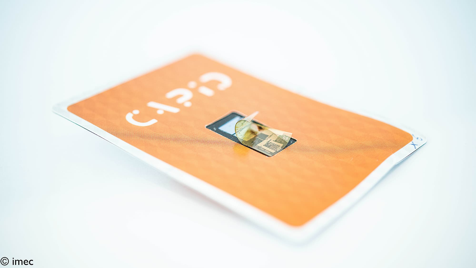 capid-c-touch003_1 Orange flexible tag with a small embedded chip, shown in a close-up product shot