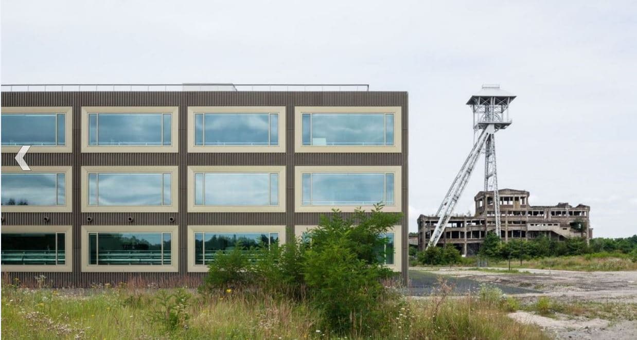 CaptureenergyvilleI_0 Modern EnergyVille building beside a former mine tower and abandoned industrial ruins
