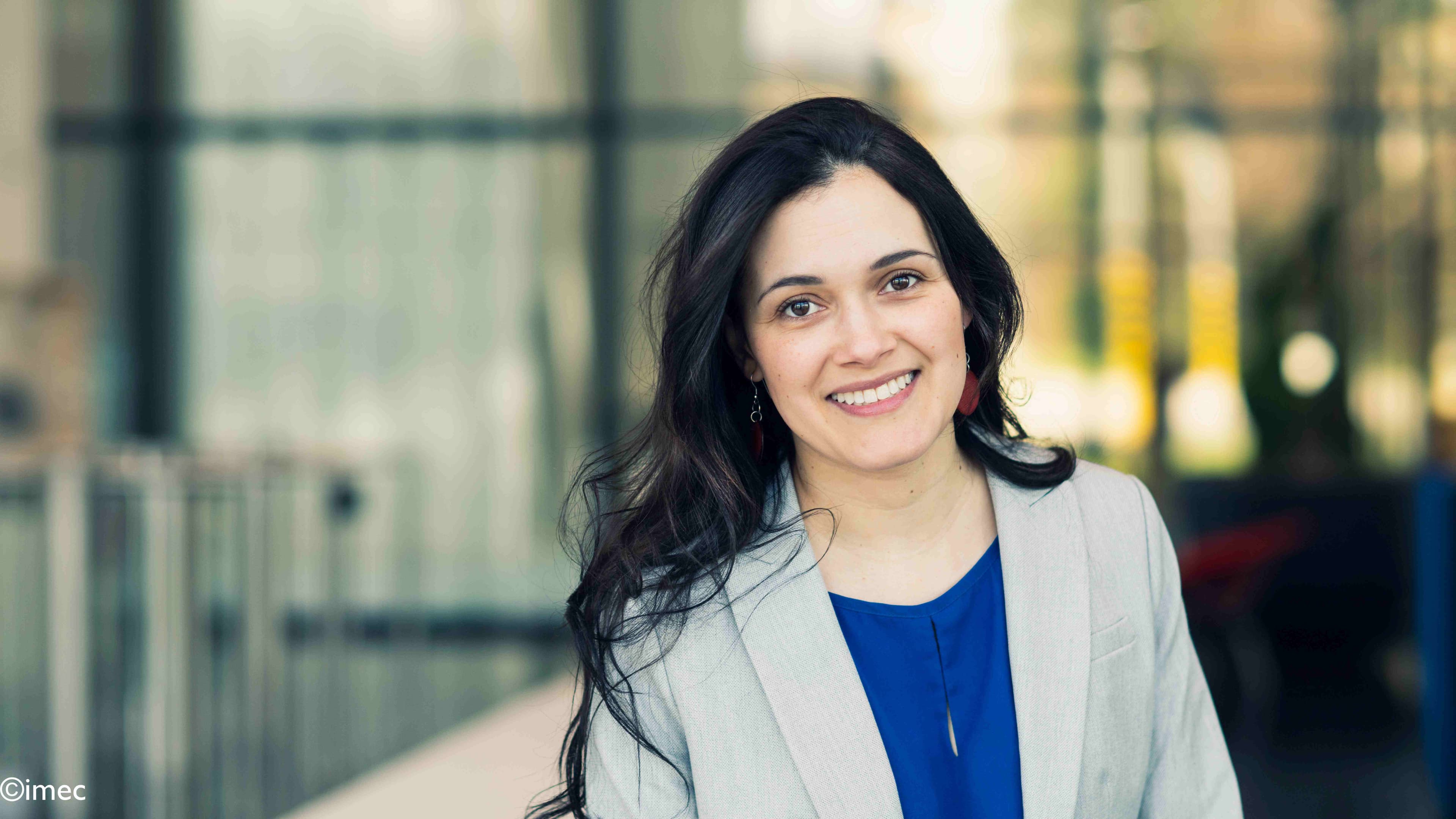 Carolina Portrait of Carolina Mora Lopez smiling outdoors in front of a modern building
