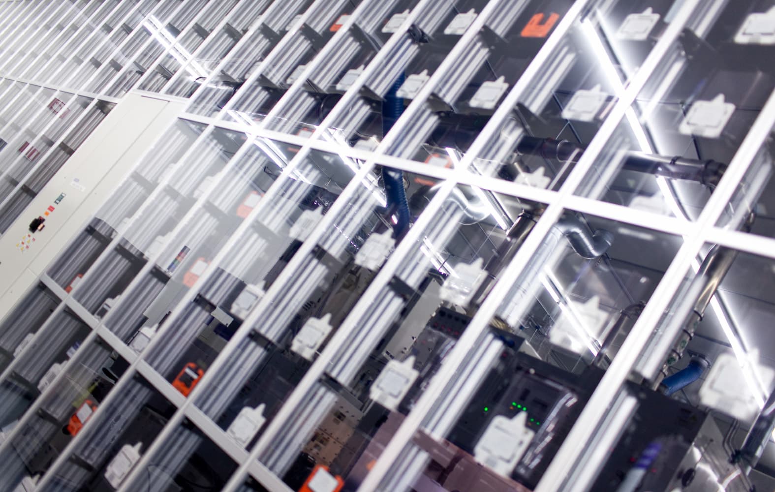 Cleanroom_14 Cleanroom equipment with rows of metallic rails and bright overhead lights