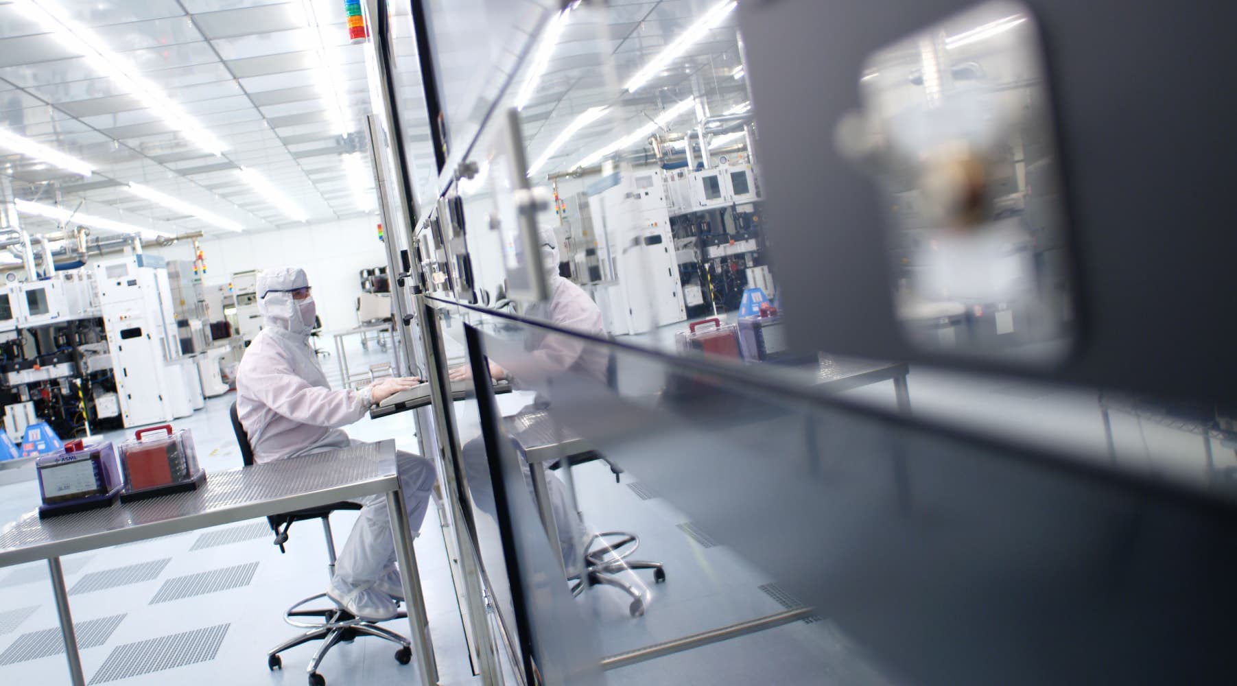 cleanroom_4 Researchers in cleanroom suits working at equipment inside a semiconductor cleanroom