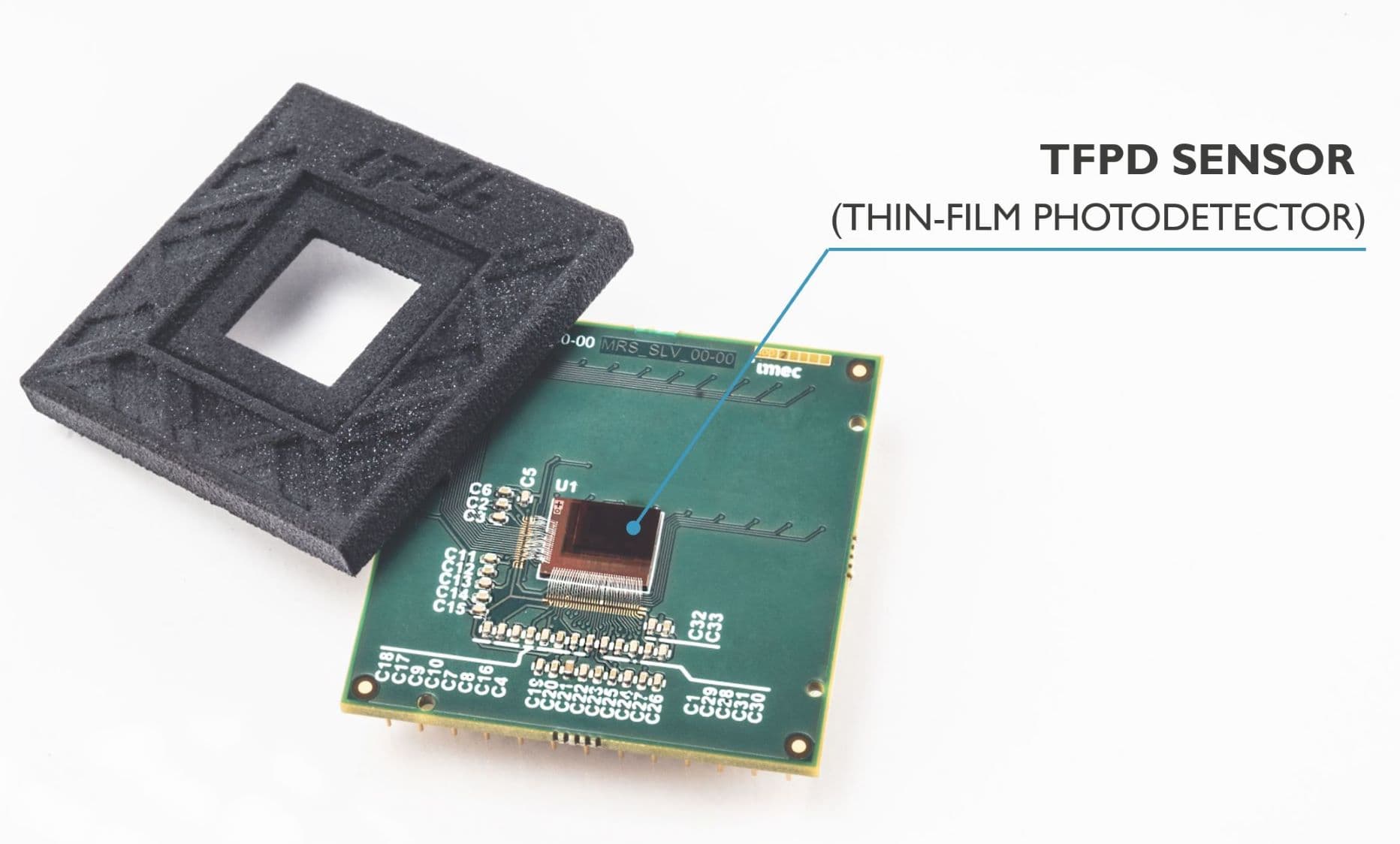 CMOS%20IR%20sensor Thin-film photodetector sensor chip on a circuit board with a protective frame above it