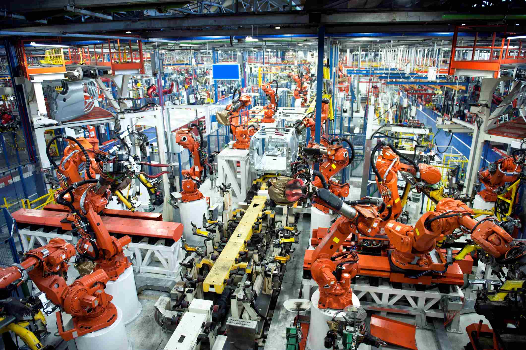 cobot%20safety Industrial robot arms operating in a factory assembly line with fenced workcells