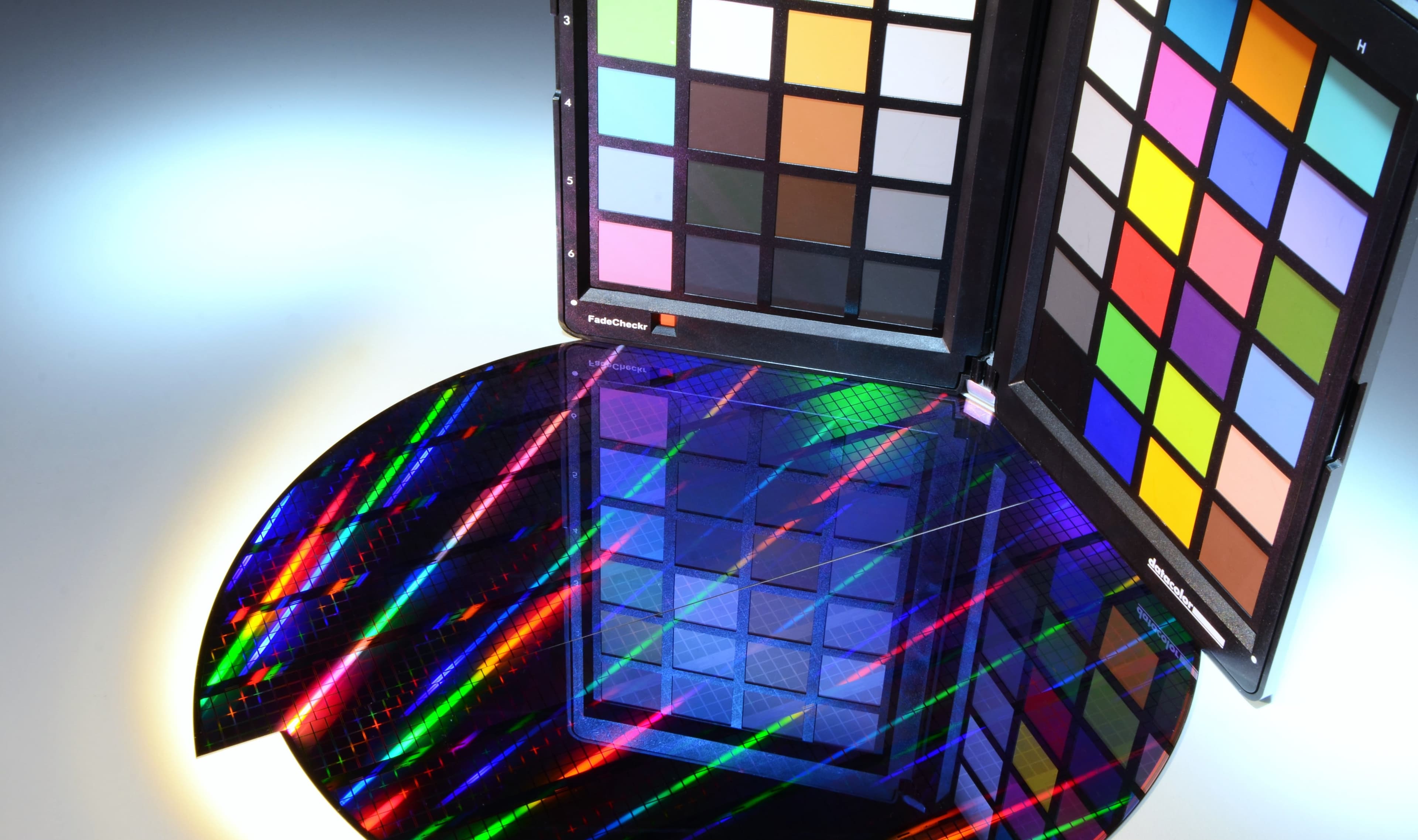 Color%20splitters Color chart panels above a glossy silicon wafer with rainbow light patterns, illustrating waveguide-based color splitting