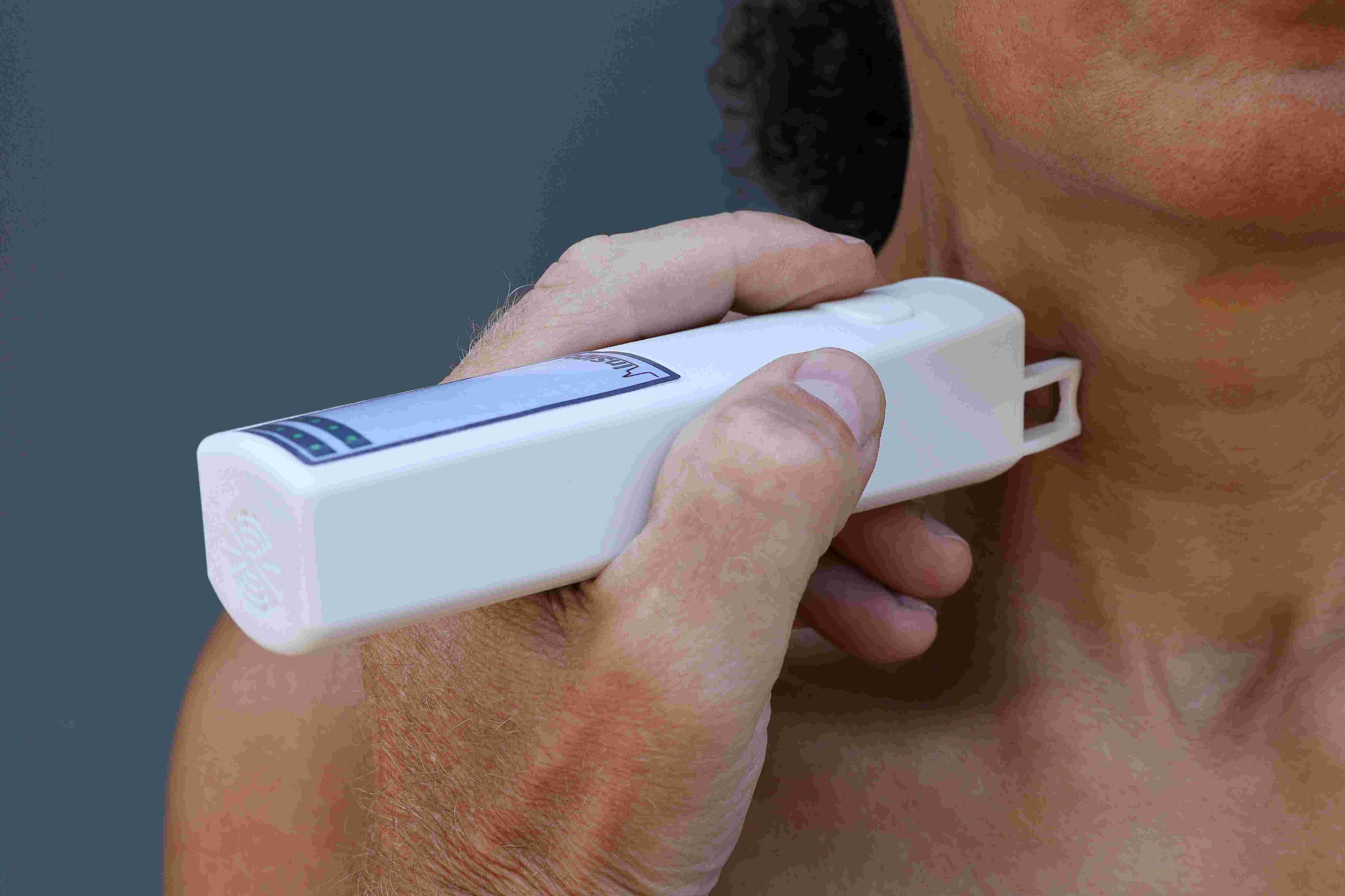 CVD%20diagnostics Handheld diagnostic device pressed against a person's neck during a medical measurement