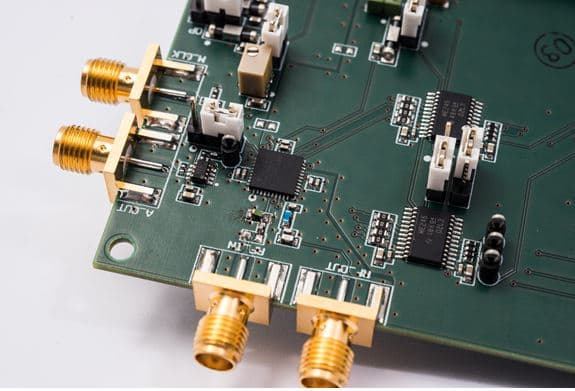 DigitalReceiver_1 Close-up of a green circuit board with RF connectors and mounted chips for a digital receiver