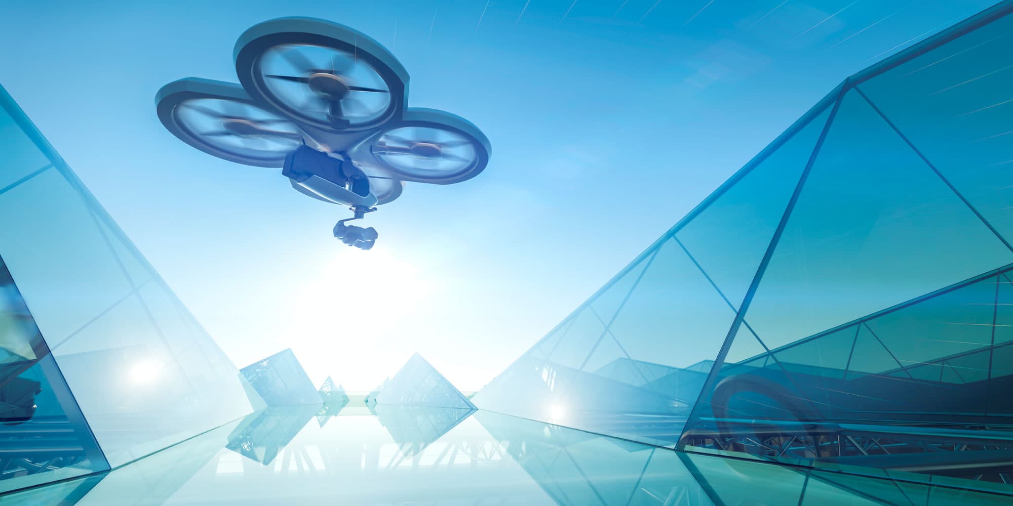 Drone Drone vliegt tussen futuristische glazen gebouwen in een blauwe lucht
