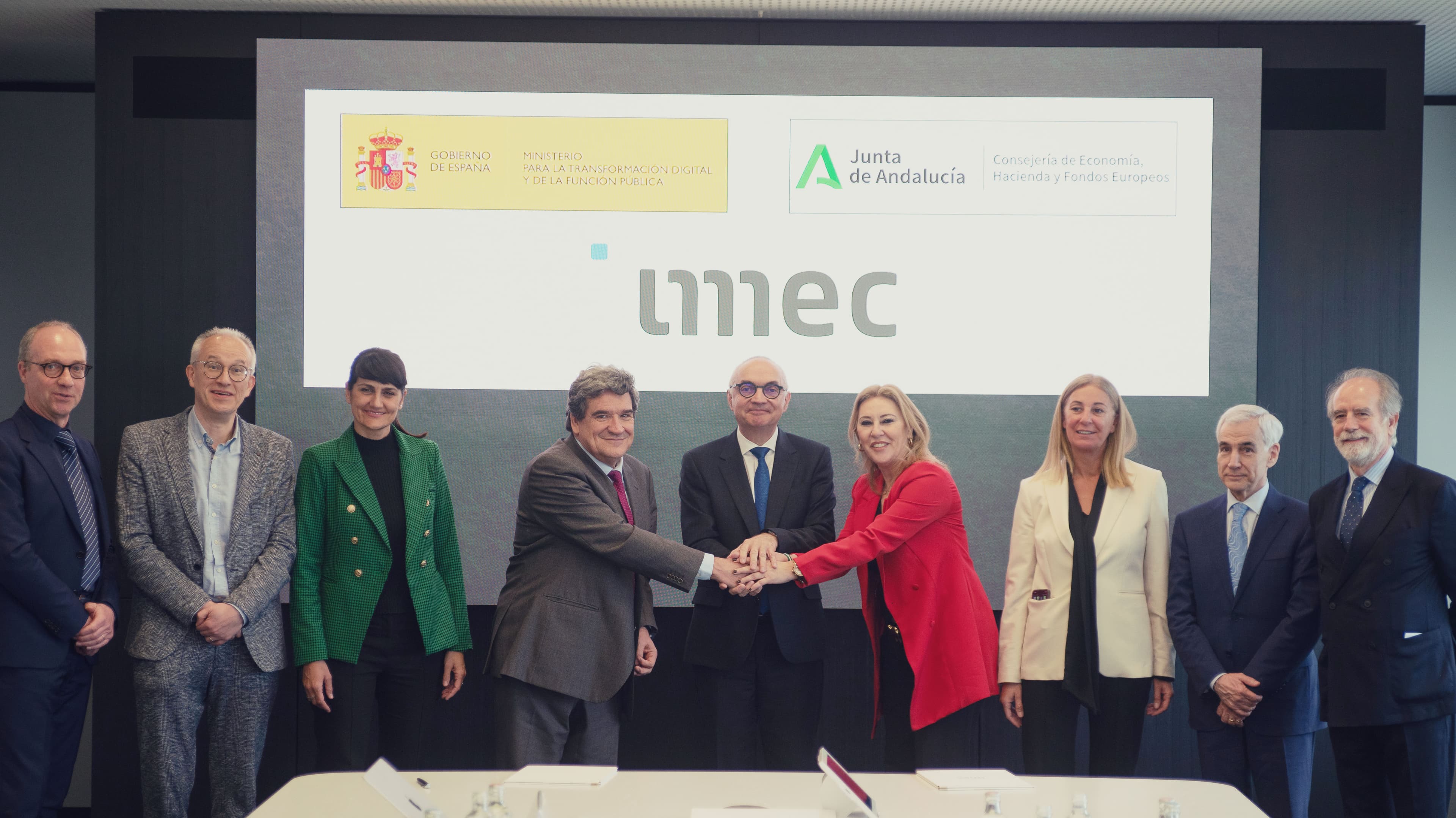 Officials and imec representatives handshake group photo Officials and imec representatives pose with a handshake beneath the imec logo and Spanish and Andalusian government logos.
