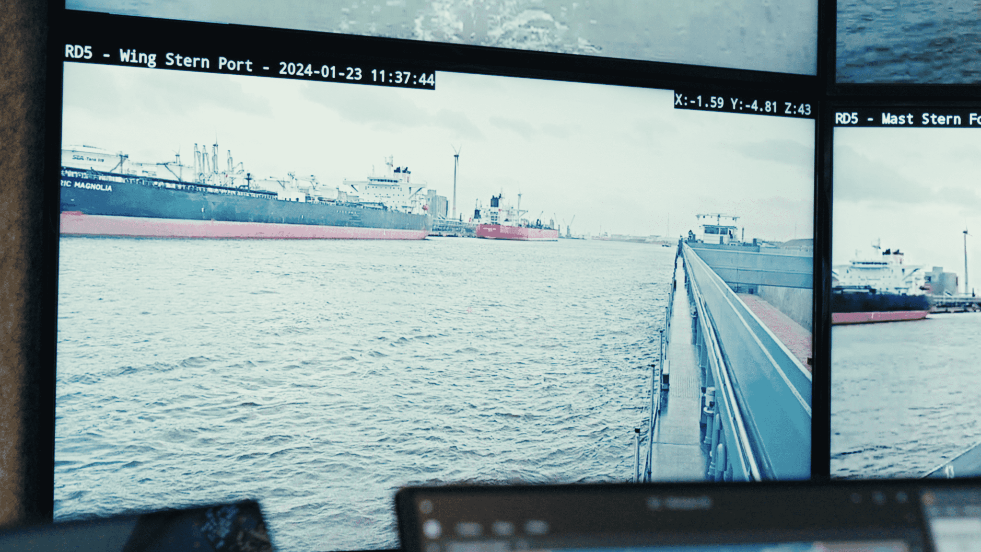 Multi-screen view of cargo vessel approaching port Multi-screen view of a cargo vessel approaching a port, with on-screen camera feeds and navigation data
