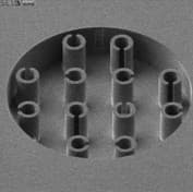 evonetix_4 Close-up of a circular silicon chip with multiple vertical microstructures on its surface