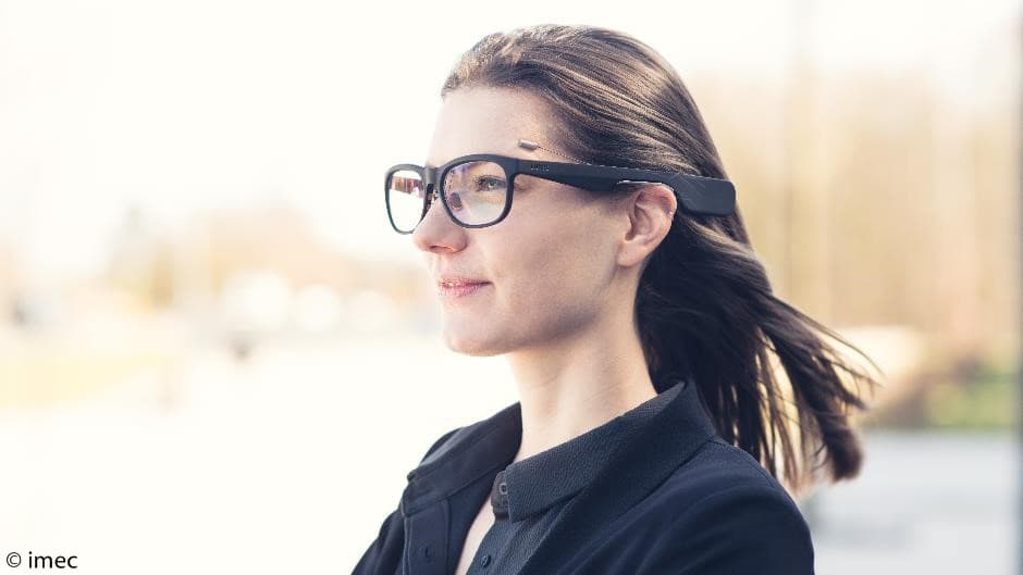 eye_tracking_-_press_release Woman wearing AR glasses outdoors, with a small eye-tracking device above the frame