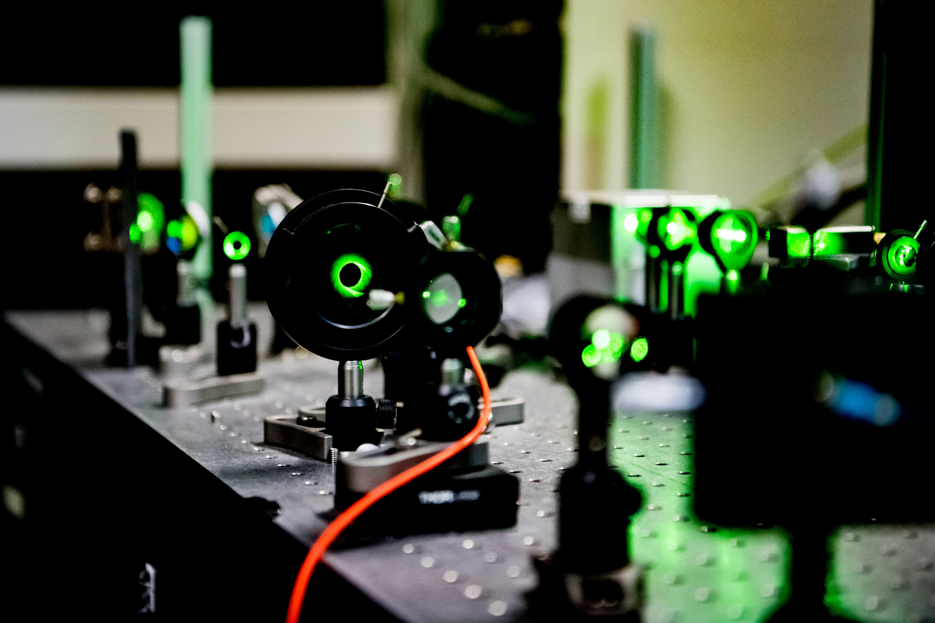 Laser beam alignment in diamond quantum chip lab setup Laser beam aligned through optical components in a lab setup for diamond quantum chip spin readout.