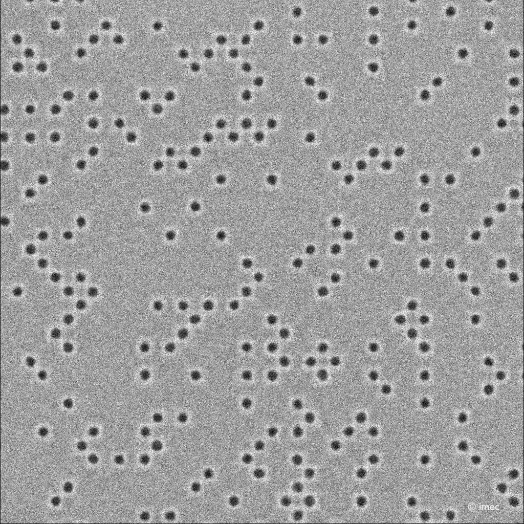 Semiconductor wafer pattern with dark vias Semiconductor wafer pattern with evenly spaced dark vias on a gray background