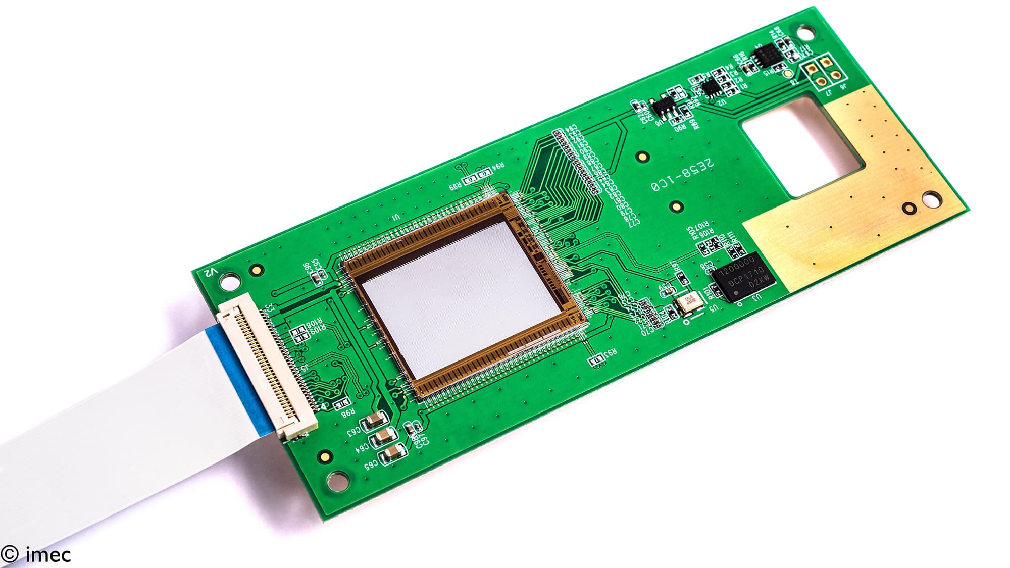 fig5_Raman_on_chip_0 Green circuit board with a central chip package and ribbon cable for on-chip Raman spectroscopy