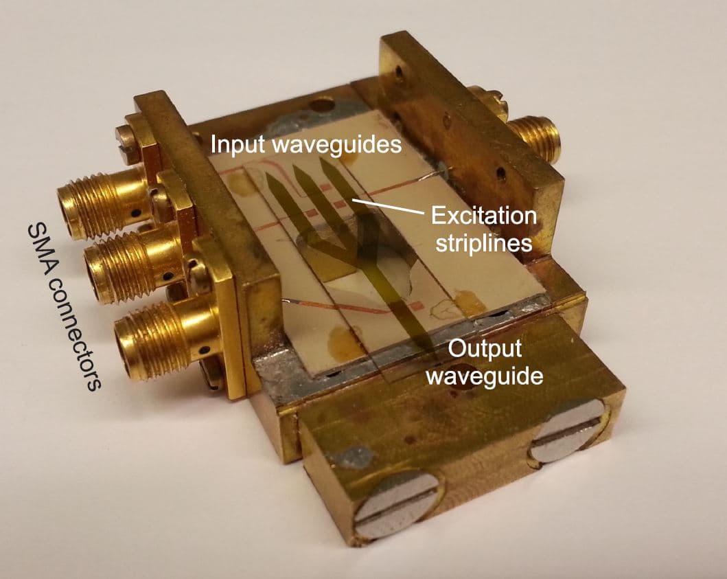 Figure_2_-_Large_scale_spin_wave_majority_gate_0 Large-scale prototype of a spin-wave majority gate with SMA connectors, input waveguides, excitation striplines, and an output waveguide.