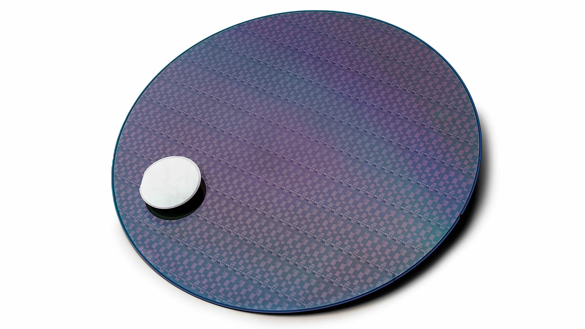 Figure-5-2-inch-InP-vs-300mm-InP-on-Si Large semiconductor wafer beside a small comparison wafer, illustrating InP scale-up on silicon