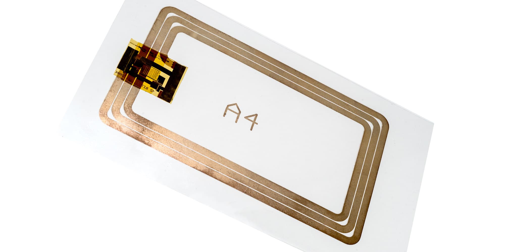 FotoRFIDtag_1 Plastic RFID tag with a screen-printed antenna and chip on a white card