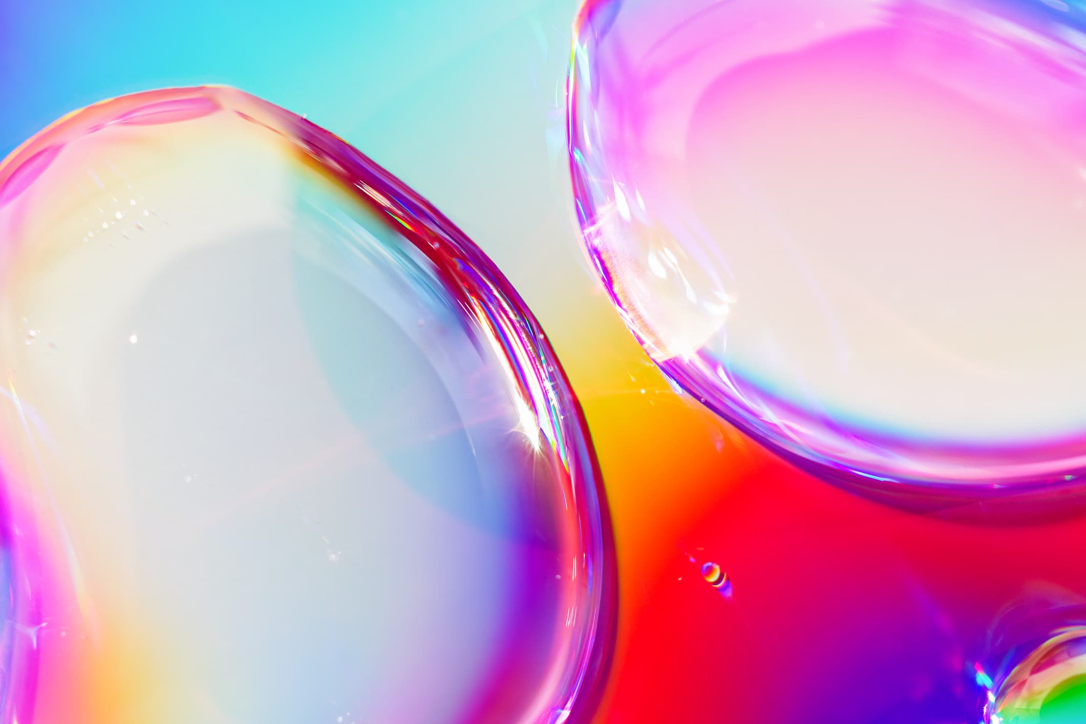 Colorful glossy liquid bubbles with rainbow reflections Colorful glossy liquid bubbles with rainbow reflections on a bright background