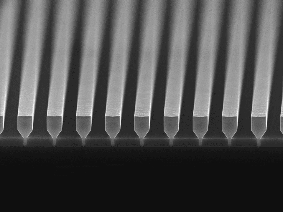 header%20nano-ridge Scanning electron micrograph of evenly spaced nano-ridge laser structures on a wafer