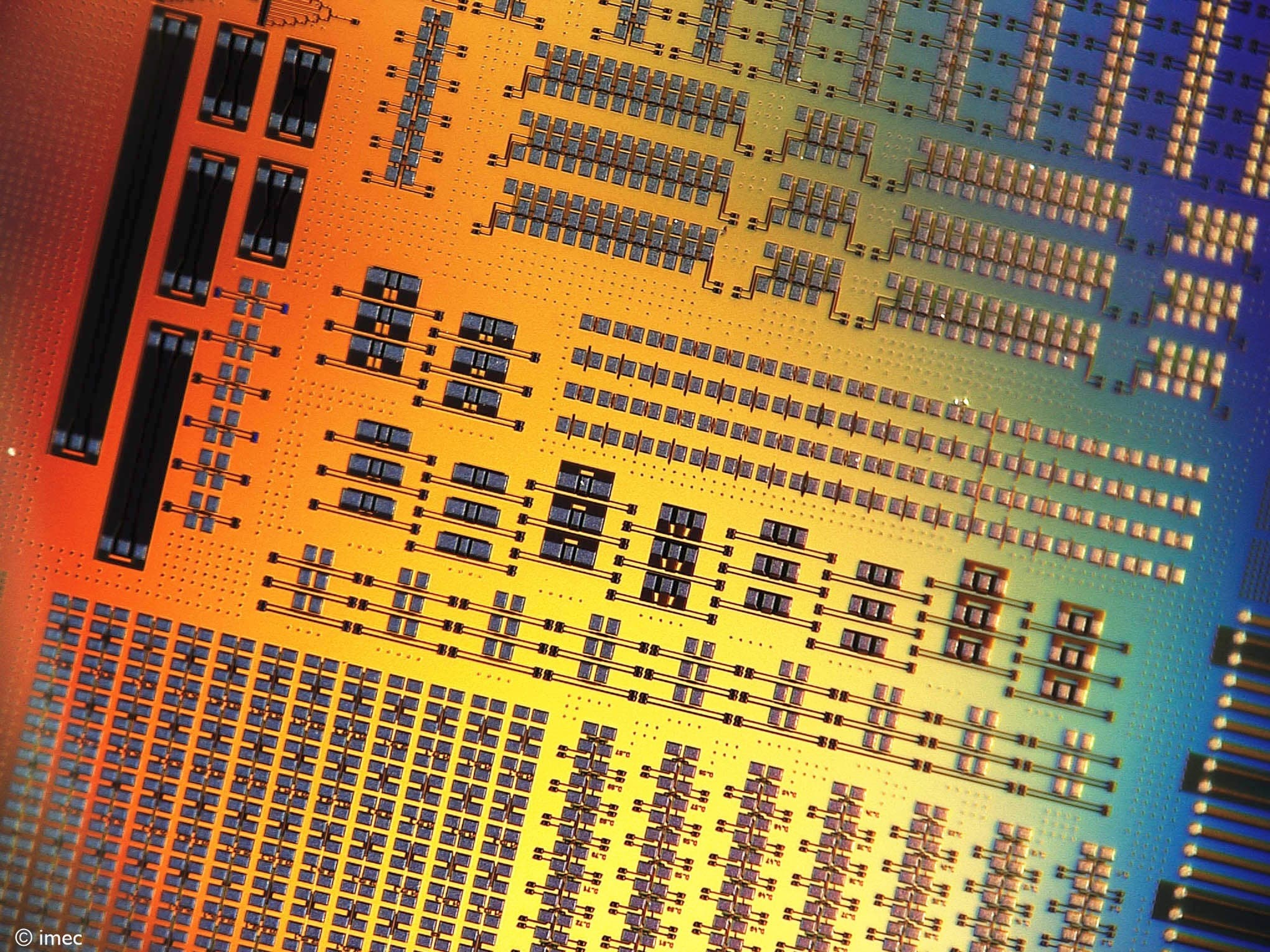 Colorful close-up of silicon photonics chip pattern Colorful close-up of a silicon photonics chip pattern with dense rectangular structures and arrays of components.