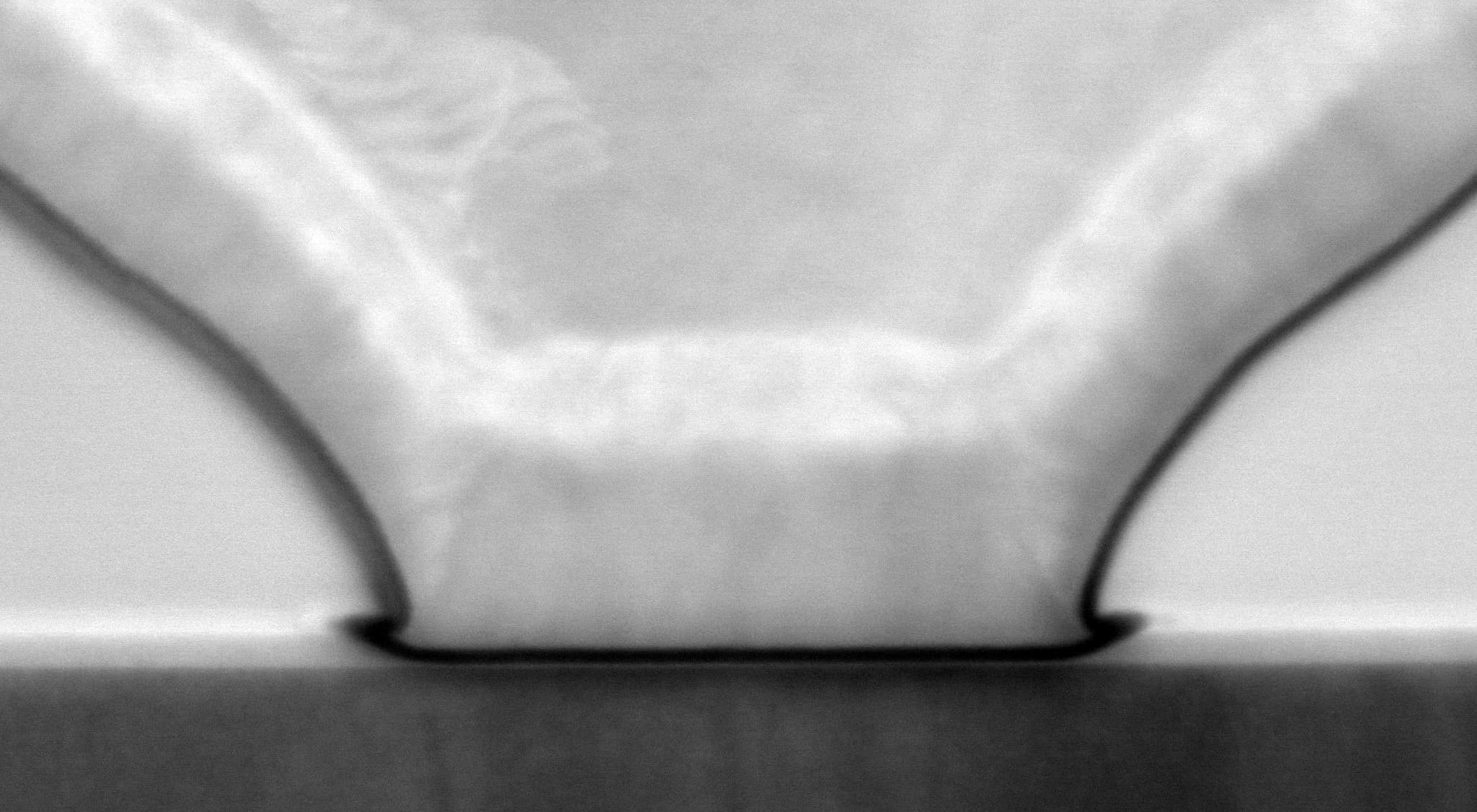 Microscope close-up of GaN-on-Si transistor structure Microscope close-up of a GaN-on-Si transistor structure with curved dark contacts