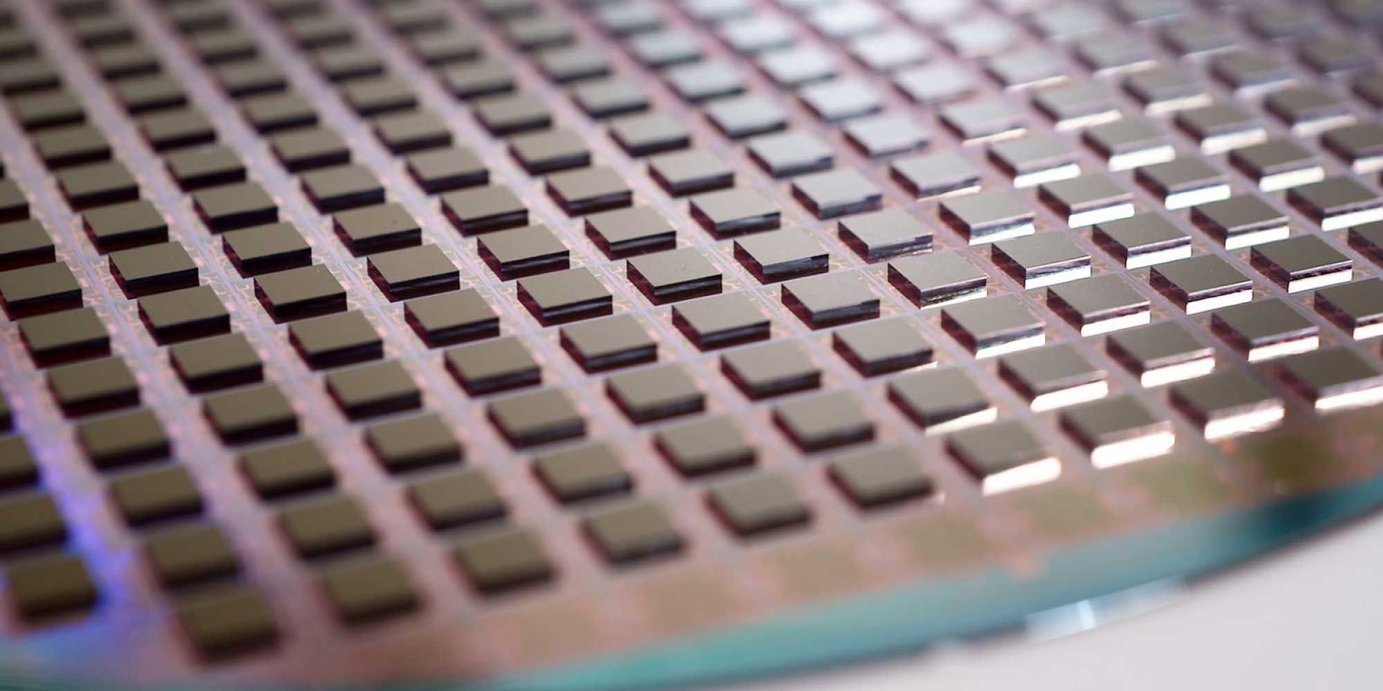 header-3D Close-up of a wafer covered with evenly spaced square semiconductor dies