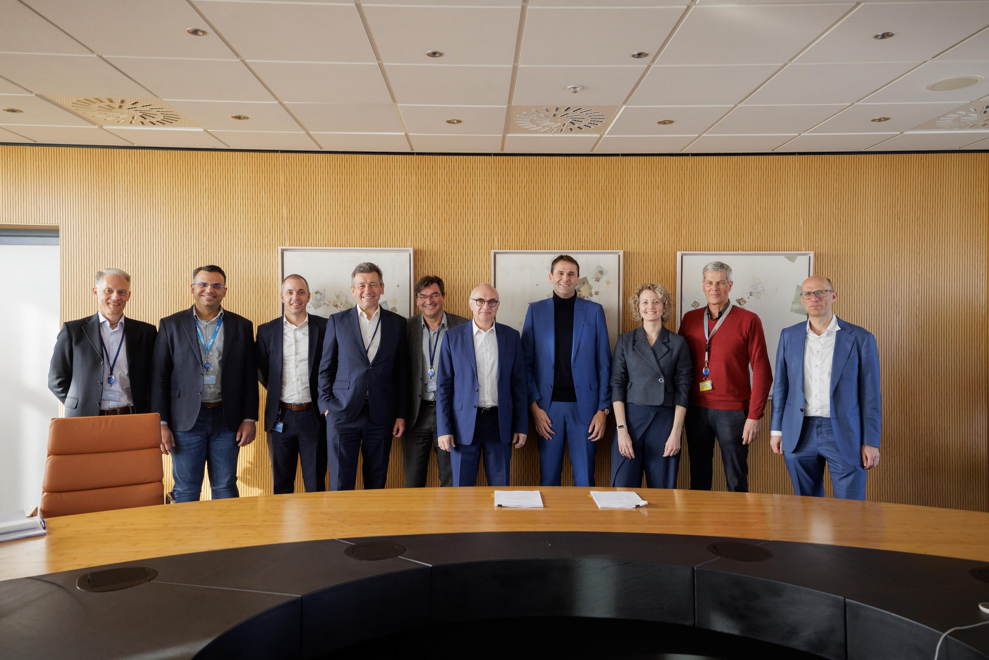 header_ASML_Signing_imec_March_2025_019_0 Group of executives posing in a conference room after signing a partnership agreement