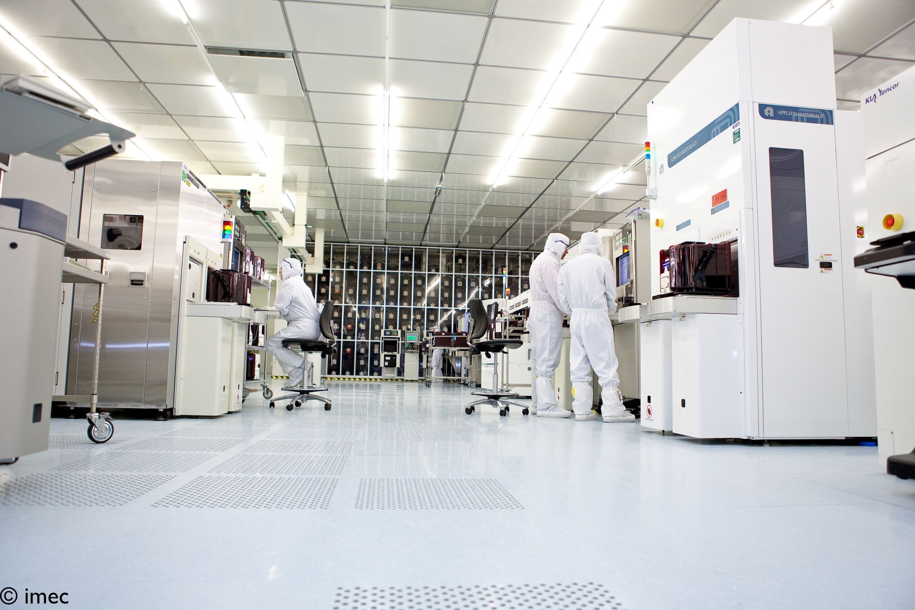 Header_cleanroom_LR Cleanroom with researchers in white suits working beside semiconductor equipment