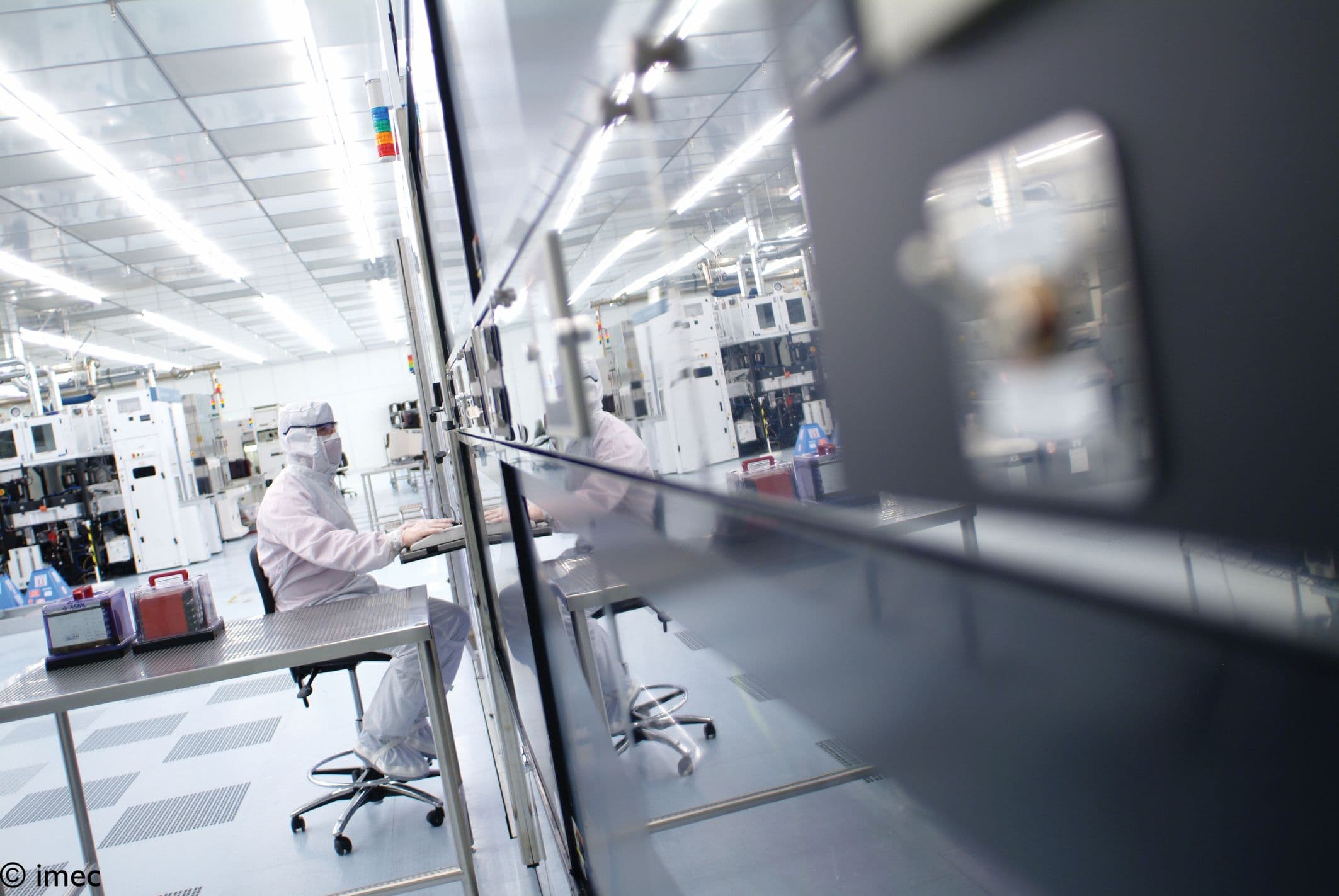 Header-LR Researchers in a cleanroom working beside semiconductor equipment
